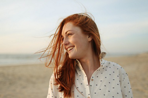 Redheaded woman in a polka-dot shirt
